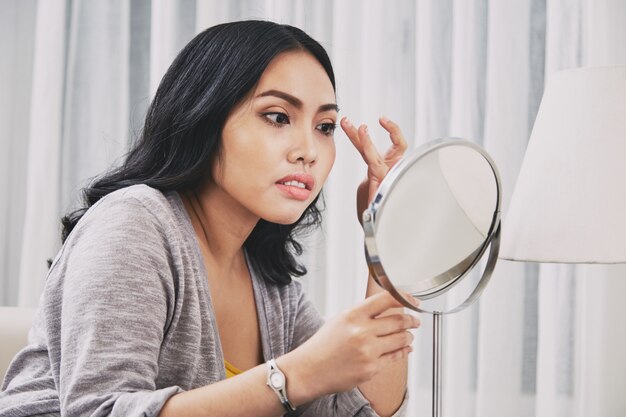 Filipino woman adjusting makeup