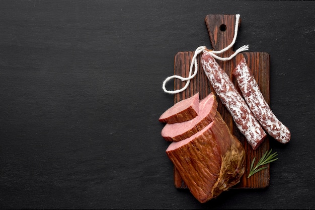 Fillet meat and salami on wooden board