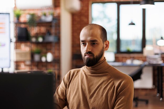 Financial department team leader researching marketing ideas while analyzing company expenses report. Startup project manager developing budget growth solutions while brainstorming promoting strategy.