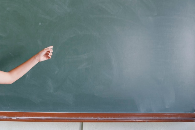 Free photo finger pointing the blackboard