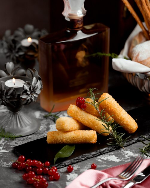 Finger potato nuggets garnished with cranberry and rosemary