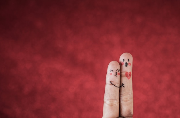 Free Photo finger with emotion on red background