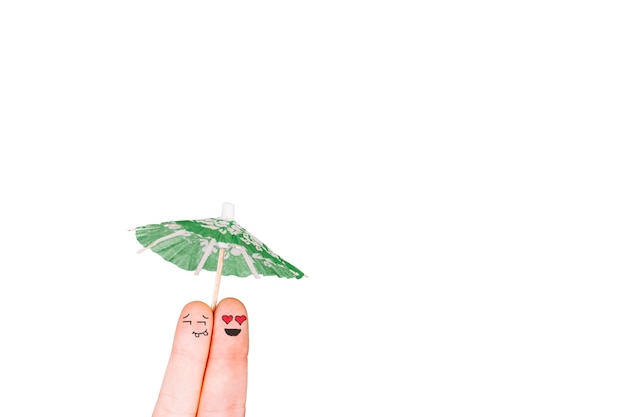 Free Photo fingers with faces holding umbrella