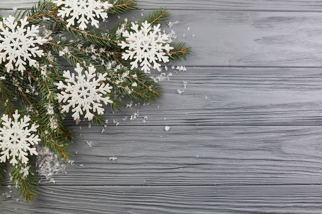 Fir branch with ornament snow and paper snowflakes