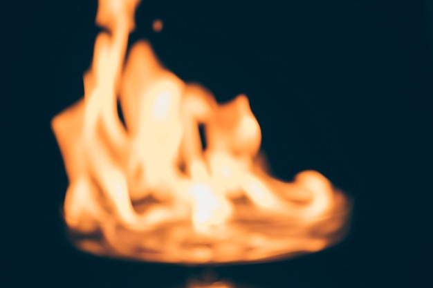 Fire burning on blurred black background