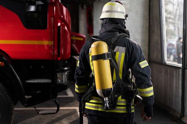 Firefighter at the station with suit and safety helmet