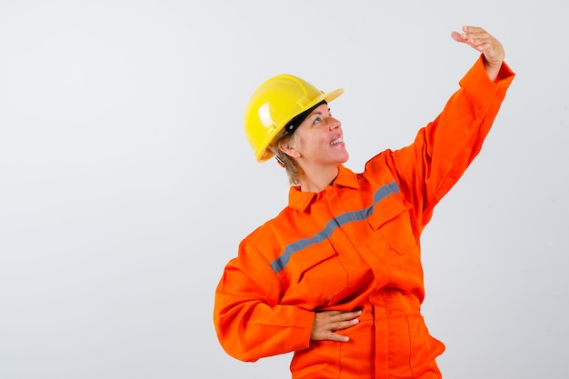 Free Photo firewoman in her uniform with a safety helmet