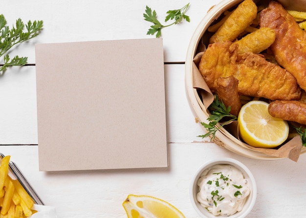 Fish and chips in bowl with lemon and card