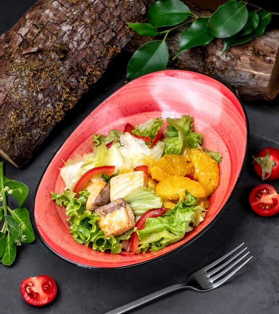 Fish salad with fruits on the table