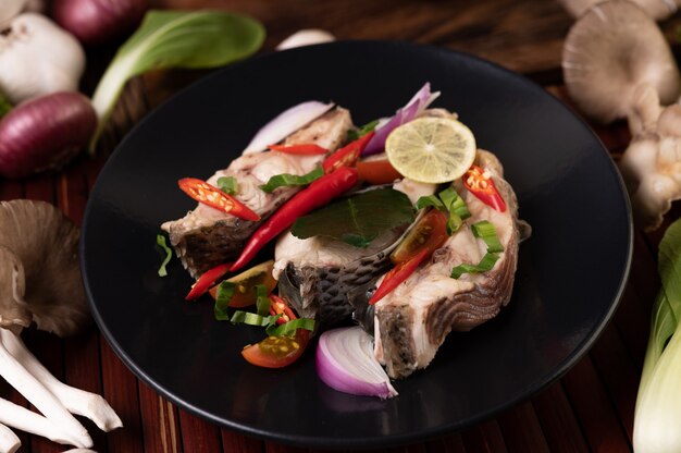 Fish salad with lime, chili, lemongrass, onions, red onions, parsley and kaffir lime leaves in the plate