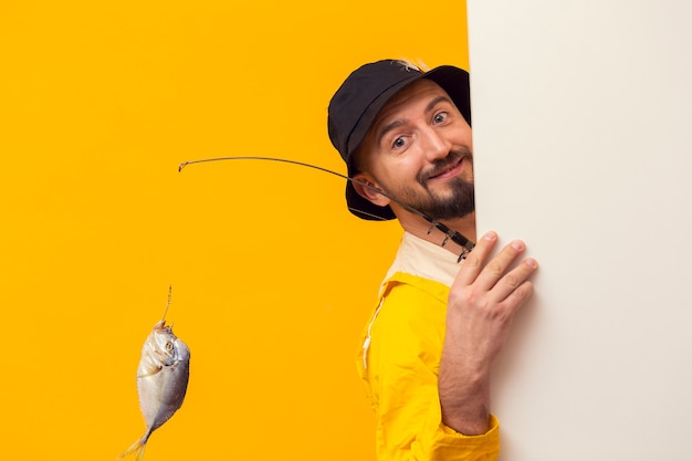 Free photo fisherman holding fishing rod and posing while smiling