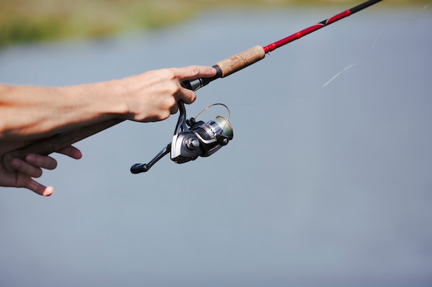 Fisherman's hand fishing on blurred background