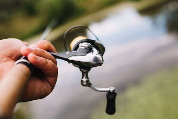 Fisherman's hand holding fishing rod