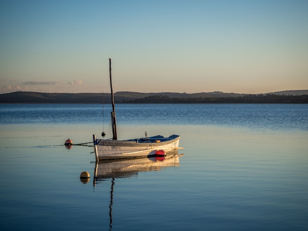 Free photo fishing boat at the river with the beautiful sunset in the background