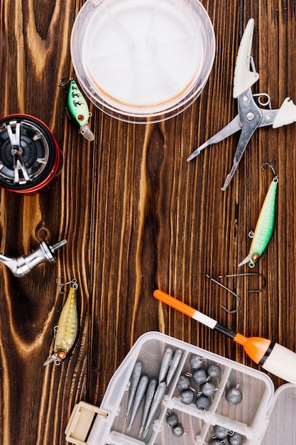 Free photo fishing equipments on wooden background texture