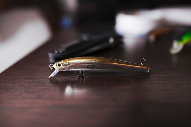 Fishing hook on wooden surface