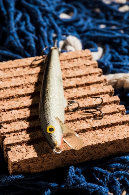 Free photo fishing lure on corkboard over the fishing net