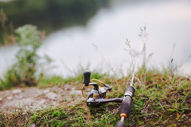 Free photo fishing rod on green grass