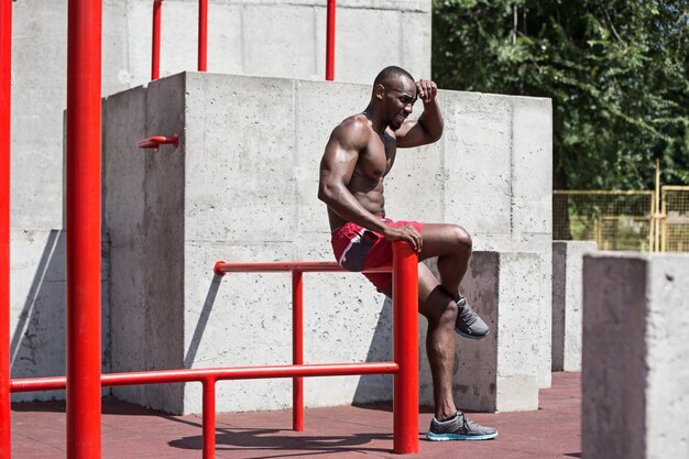 The fit athlete doing exercises at stadium