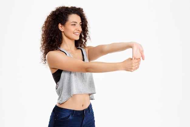 Fit curly girl doing fitness exercises