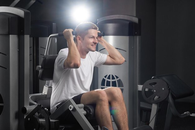 Fit energetic smiling man on power training