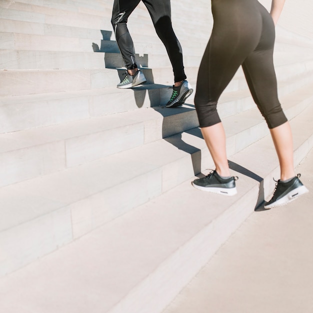 Free photo fit girls walking up stairs