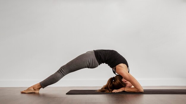 Fit woman doing yoga at home