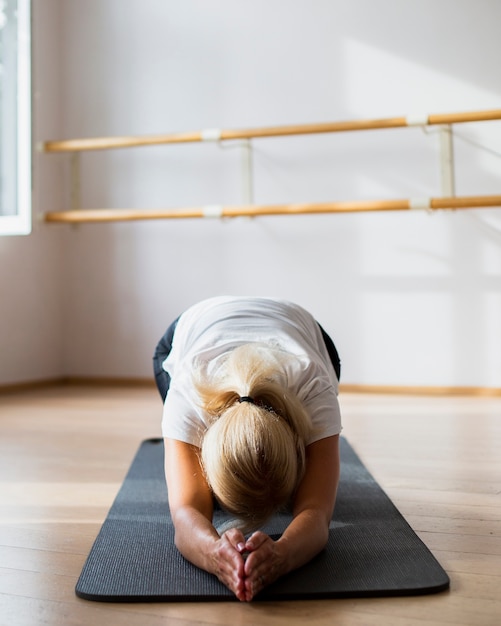 Fit woman stretching her body 