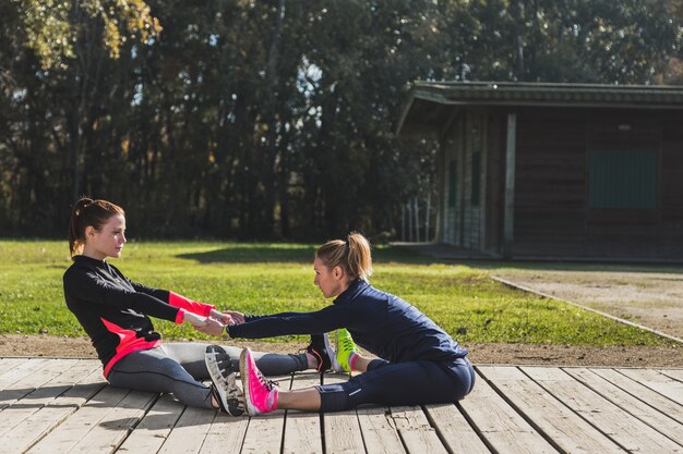 Fit women warming up together outdoors