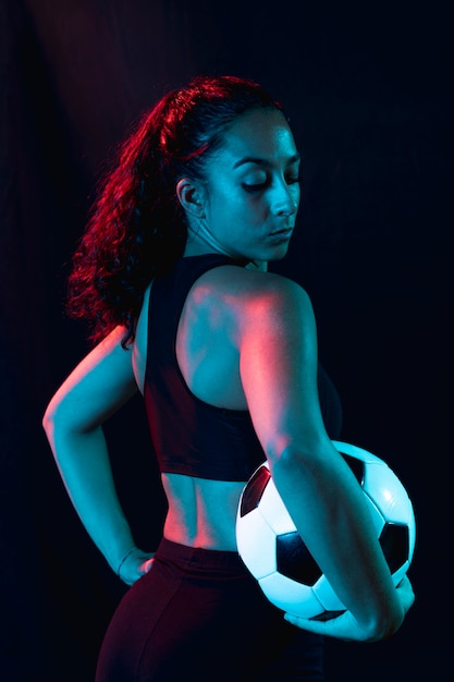 Fit young girl holding soccer ball