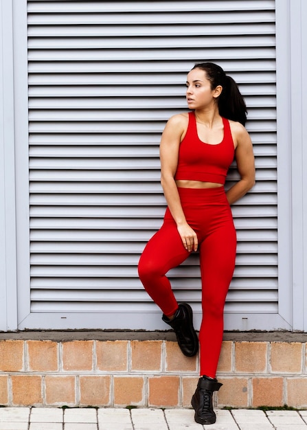 Fit young woman in sportswear posing