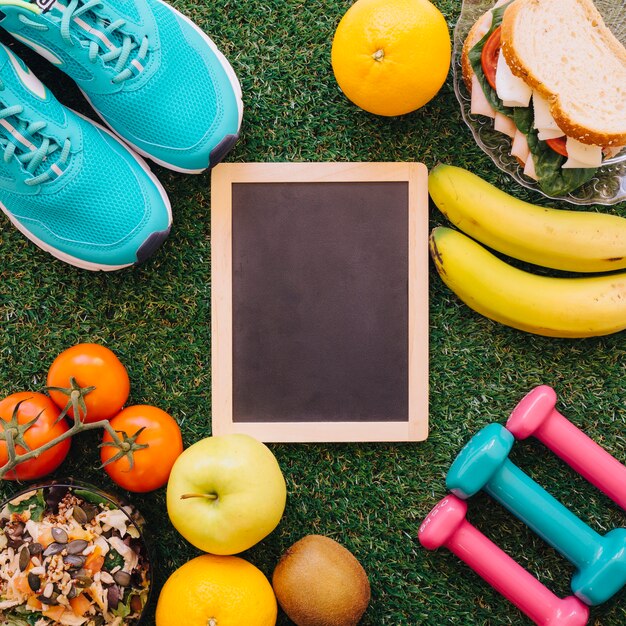 Fitness concept with slate, fitness objects and food