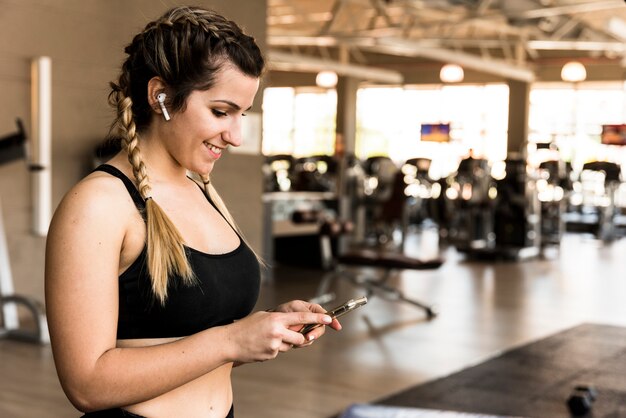 Fitness girl using her mobile phone