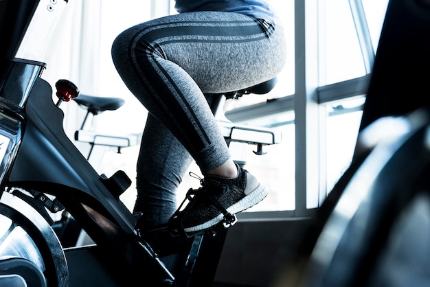 Fitness girl using stationary bike