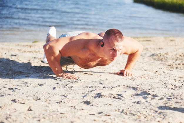 Fitness man training push up. Sport, exercise, fitness, workout. Healthy lifestyle. sunrise early morning backlit