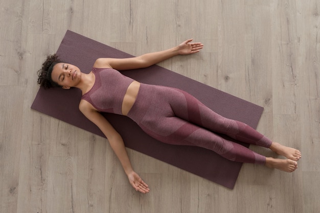 Fitness woman doing yoga on a yoga mat at home