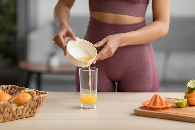 Fitness woman preparing a healthy fruit juice