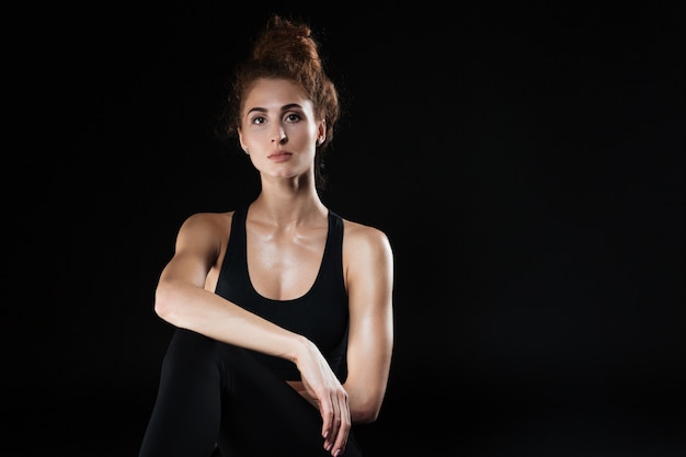 Fitness woman sitting in studio