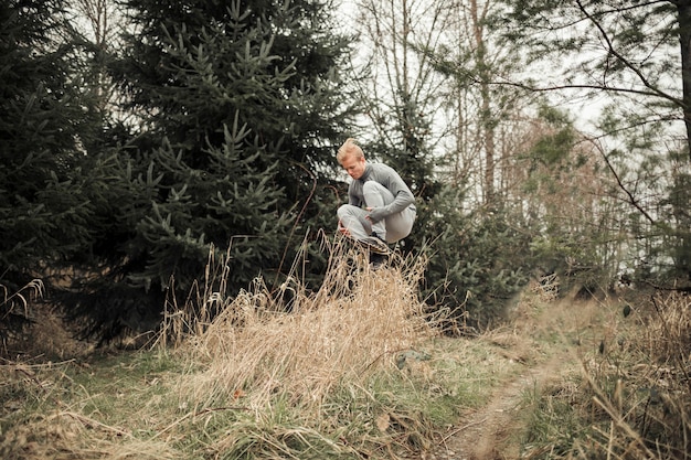 Fitness young man leaping over the grass