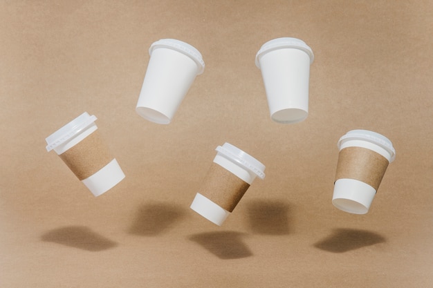 Free Photo five coffee cups in air