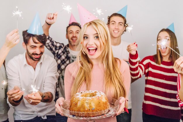 Five friends with birthday cake