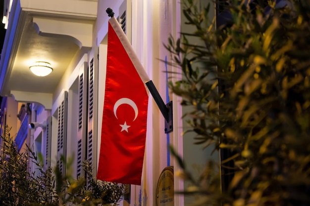 Free photo the flag of turkey on a hotel door at night