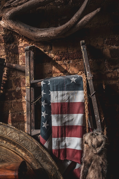 Free photo flag of the united states hung on a metal stand in an ancient attic