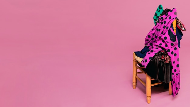 Flamenco dresses on chair with pink background