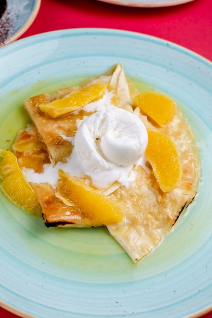 Flapjack with ice cream and orange