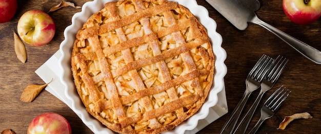 Flat lay of apple pie for thanksgiving with autumn leaves