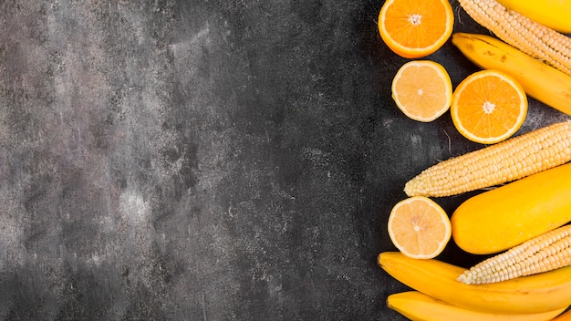 Flat lay arrangement of maize and oranges with copy space