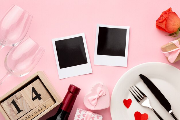 Flat lay arrangement for valentine's day dinner on pink background