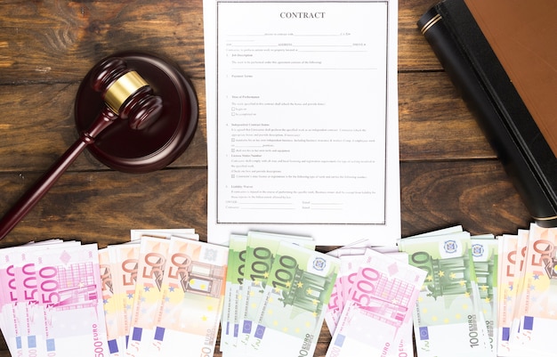 Flat lay arrangement with banknotes, book, contract and gavel