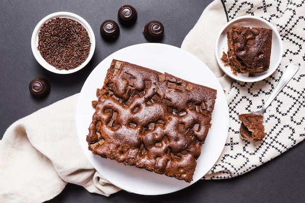 Flat lay arrangement with chocolate cake and candies